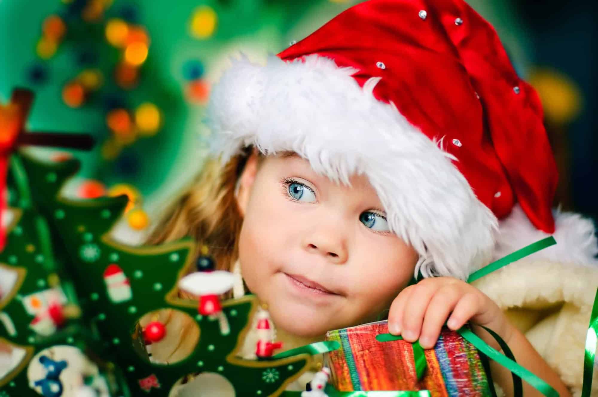 Little girl looking at a Christmas treeLittle girl looking at a Christmas tree