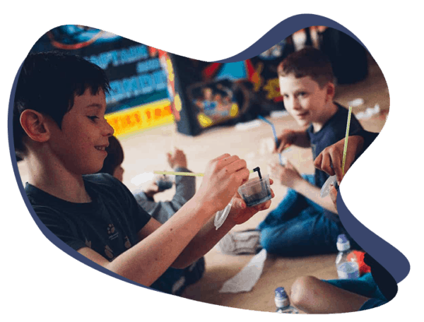 kids smiling and doing science experiments and enjoying science party