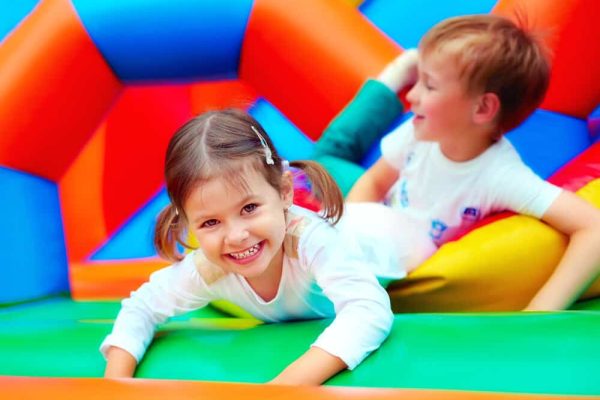 happy kids having fun on playground in kindergarten